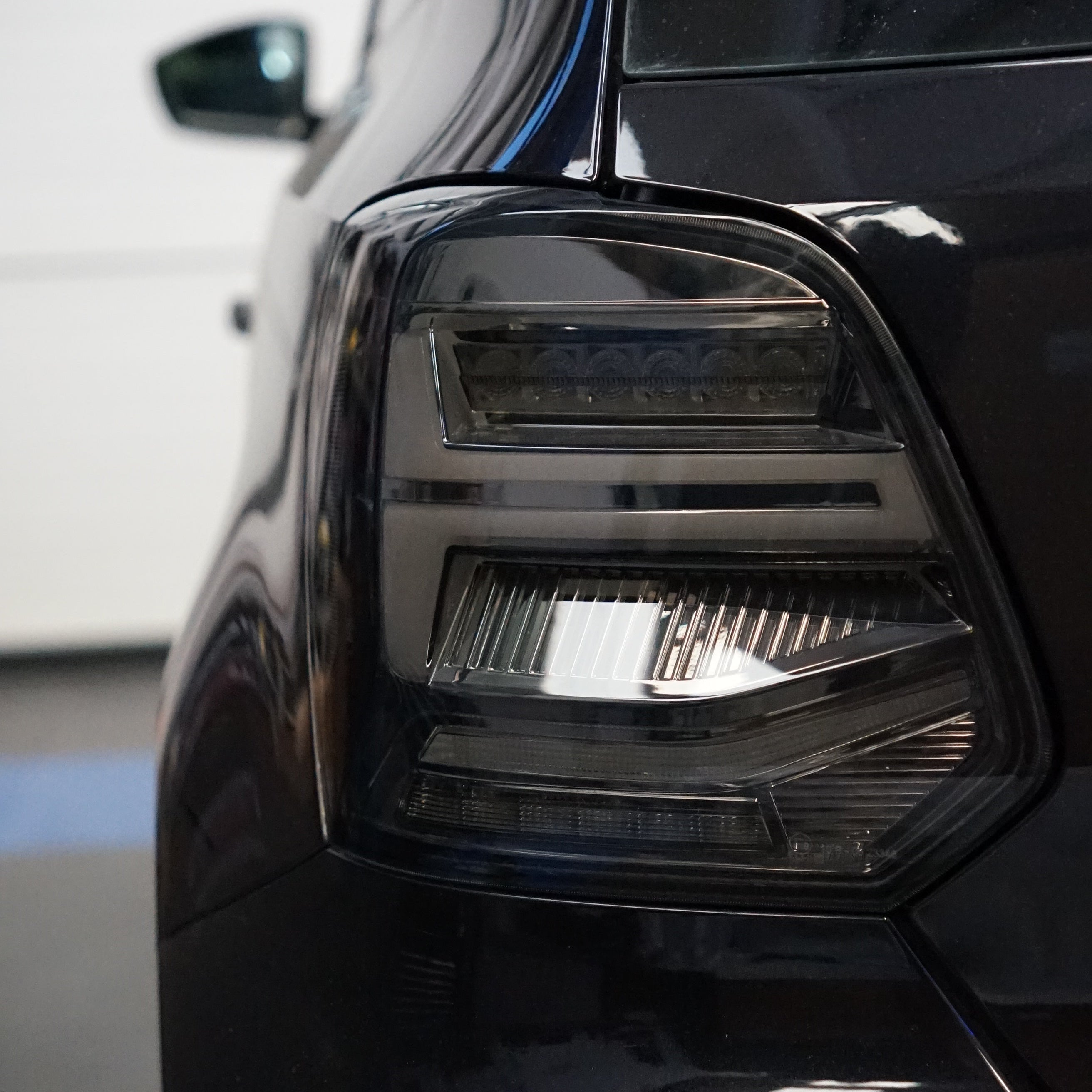 Close-up of a car headlight with a blurred background