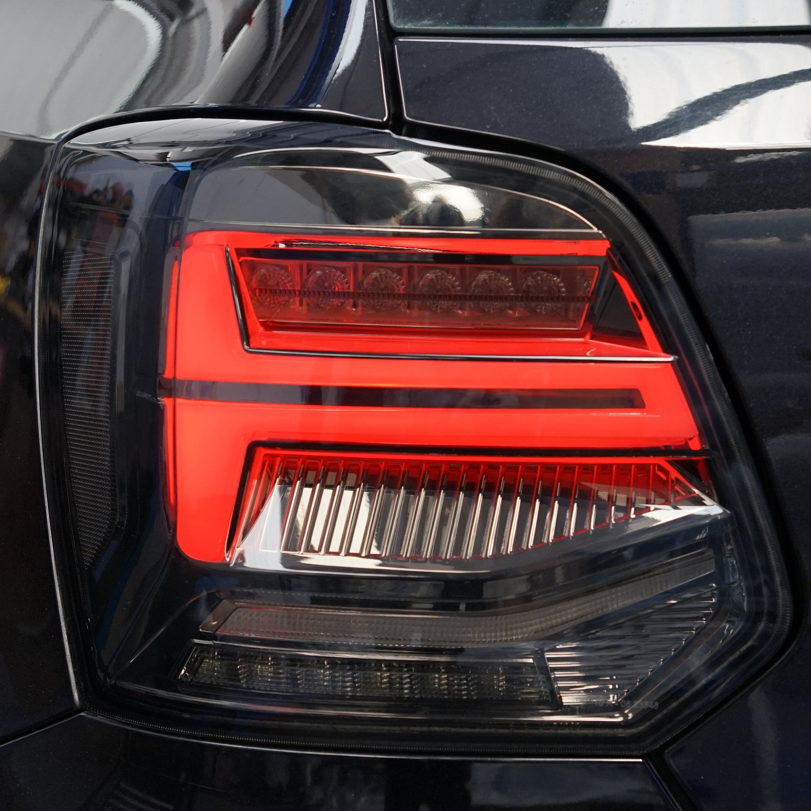 Close-up of a car's taillight with a red and black design.