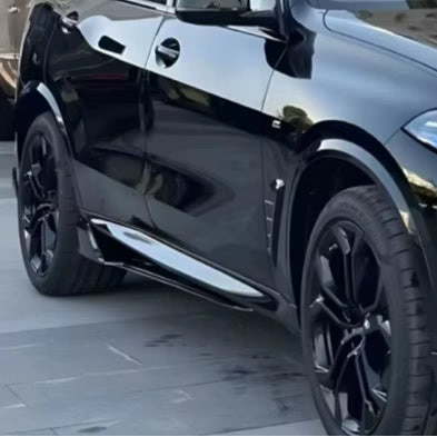 Two long black automotive body panels or trim pieces shown above a black SUV on a paved outdoor surface. The product appears to be the two glossy black trim/panel pieces, with the car used as contextual reference rather than the sold item.