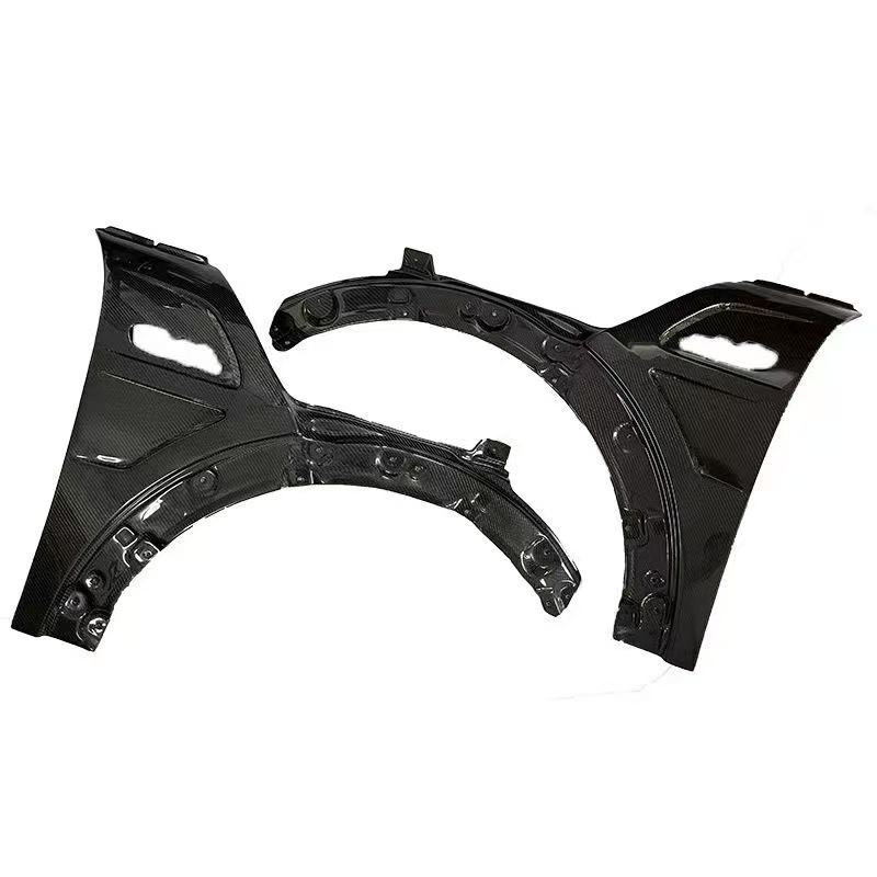 A pair of black carbon fiber front and rear fenders with a glossy finish, displayed on a clean white background.