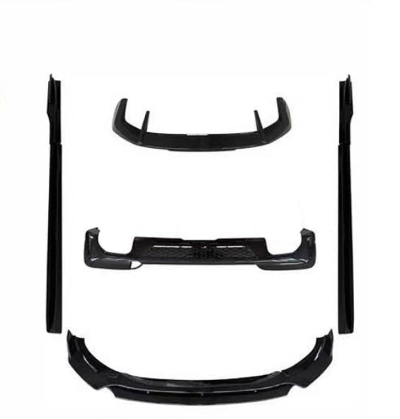 A set of black automotive body parts, including a front lip, rear lip, side skirts, and an exhaust assembly, arranged on a plain white background.